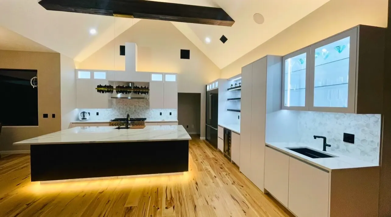 Contemporary kitchen with a dark waterfall island and handleless cabinetry