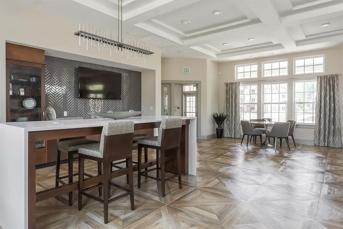 Kitchen and bar area with counter seating, coffered ceiling and wood flooring