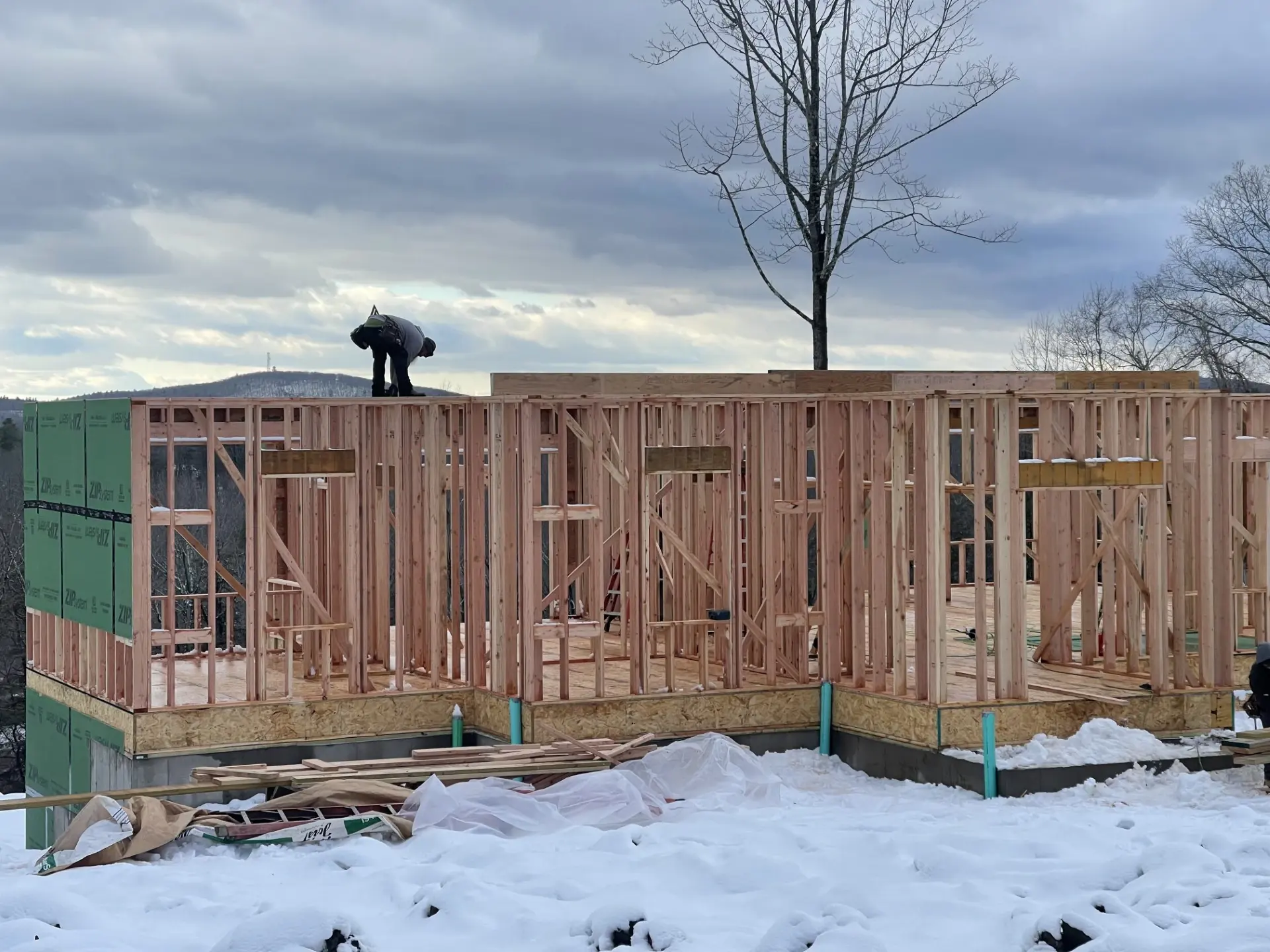 New addition framed and sheathed on a winter job site